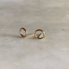 These simple circle earrings feature an open 7-millimeter circle made from round wire. This design is lightweight and comfortable to wear. They are 14K gold-filled and come with gold-filled earring backs. Each earring measures less than 1 gram. What does gold-filled mean? — Read about gold-filled jewelry here! Shop MIMOSA's Studs. *These tiny studs are sourced from Albuquerque, New Mexico. Almost everything at MIMOSA is handcrafted in Louisiana. But from time to time, we find "supporting actor" Dainty Circle Earrings In 14k Gold, Minimalist 14k Gold Filled Circle Earrings, Dainty 14k Gold Circle Earrings, Gold Minimalist Open Circle Earrings, Minimalist Gold Open Circle Earrings, Dainty Yellow Gold Circular Earrings, Everyday Yellow Gold Open Circle Earrings, Yellow Gold Circle Earrings, Bronze Earrings