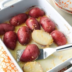 potatoes in a casserole dish with butter and seasoning