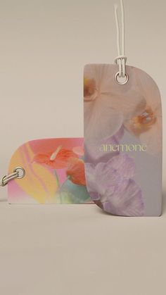 two tags with flowers on them sitting next to each other and one tag has the word, ammone