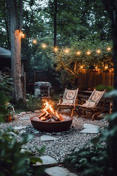 Cozy backyard with a fire pit, string lights, and two wooden chairs. Small Terrace Fire Pit, Large Fire Pit Ideas Outdoor Spaces, Bon Fire Pit Ideas Backyards, Outdoor Fire Pit Patio Ideas, Backyard Corner Fire Pit Ideas, Fire Pit In Woods, Natural Fire Pit Ideas, Simple Outdoor Patio Ideas, Rustic Fire Pit Ideas Backyard