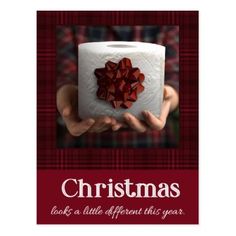 a christmas card with a red bow on top of a roll of toilet paper and the words, christmas looks a little different this year