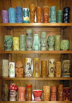 a shelf filled with lots of different colored cups