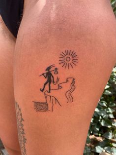 a woman's leg with a tattoo on it that has an image of a man and a dog