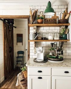 a kitchen with white cabinets and open shelves