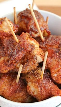 meatballs with toothpicks in a white bowl