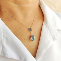 "This stunning necklace is set in 14K solid yellow gold with natural sky blue topaz gemstones. It is an unique minimalist necklace and is therefore completely hassle-free jewelrym * Gem: Sky Blue Topaz * Gem Size: Top Stone- 6x8mm, Bottom Stone- 10x14mm * Total Gem weight: 7.35 carats * Gold purity: 14K * Gold weight: 2.44 grams  * Gross weight: 3.91 grams * Chain Length: 16\" inches The Gold purity is guaranteed and it comes with authentic 14KT gold hallmark. Since my items are handmade, they are absolutely nickel and lead free. CUSTOMIZATION: * Gemstone customization is available and it can be substituted with a gem of your choice. Kindly message me for the same. PACKAGING * The Pendant comes with layers of safe and secure wrapping along with Free handmade jewelry box with every purchase December Birthstone Necklace, Golden Rutilated Quartz, Handmade Jewelry Box, Topaz Jewelry, Bezel Pendant, Sky Blue Topaz, Yellow Gold Pendants