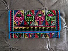 "Vintage bohemian folk art small clutch or wallet.  Beautiful cross stitching in a bohemian folk art pattern. Vibrant, bright colors. Small snap closure. Interior has four compartments, one has a zipper, while the other three are open slots. Excellent vintage condition. Measurements Length: 7.5\" Height: 4\"" Bohemian Clutch, Plastic Canvas Stitches, Beautiful Cross, Small Clutch, Beaded Purses, Cross Stitching, Vintage Bohemian, Plastic Canvas, Beautiful Bags