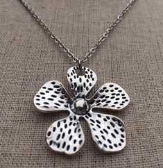 Big, bold and unique silver flower pendant necklace.  simple, refined and eye catching.  It has incredible detail and design.  The perfect everyday necklace for any nature lover.  The pendant measures 1 3/8” long by 1 3/8” wide and made from allergy free plated silver.  It hangs from a simple shiny 18” stainless steel necklace chain with a lobster clasp.I have matching earrings in my shop if you would like the whole set.  Here is a direct link............ https://etsy.me/37xz8Ql Thanks for stopp Silver Alloy Flower Pendant Necklace, Elegant Flower-shaped Large Pendant Jewelry, Silver Flower-shaped Metal Necklace, Sterling Silver Nickel-free Pendant Flower Necklace, Vintage Silver Flower-shaped Necklace, Infinity Earrings, Flower Statement Necklace, Boho Hoop Earrings, Arrow Earrings