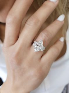 a woman wearing a diamond ring on her finger