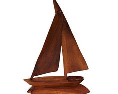 a small wooden sailboat on a white background