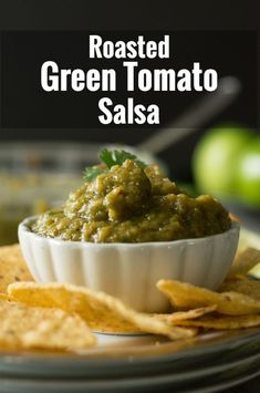 roasted green tomato salsa in a white bowl with tortilla chips on the side