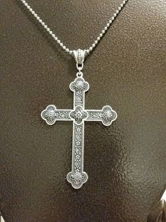 This cross pendant set in silver-toned metal makes a gorgeous necklace. It's very large and detailed. It's a budded style with lots of designs. It's reversible, too. On one side the ends have concave areas. On the reverse they're convex. This cross itself measures 59mm wide by 80mm long. With the bail and jump ring, it is 96mm long. It hangs from a decorative metal bail. It is photographed with a simple ball chain but can be purchased as the pendant only, with the ball chain, or with a nicer cha Silver Cross Necklace With Large Pendant, Ornate Silver Cross Pendant Necklace, Ornate Silver Cross Necklace, Metal Cross, Cameo Pendant, Decorative Metal, Cross Jewelry, Cross Pendant Necklace, Gorgeous Necklaces