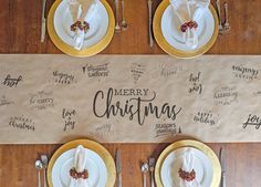 a table set for christmas with place settings and napkins on it, along with silverware