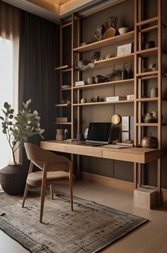 a desk with a laptop on top of it in front of a book shelf filled with books