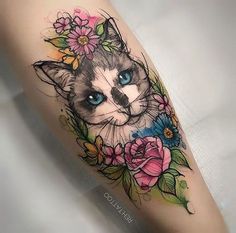 a cat with blue eyes and flowers on its leg is shown in this tattoo design