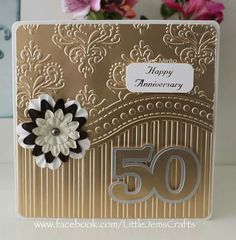 a 50th anniversary card with a flower on the front and an embellishment in the back