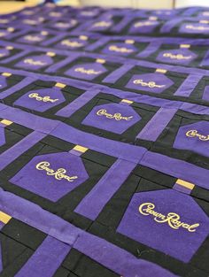 purple and black quilt with gold lettering on it