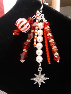 a necklace with beads and charms hanging from it's side on a mannequin