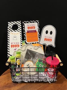 a basket filled with halloween items on top of a wooden table