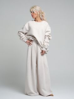 Find your comfort zone in our ecru loungewear set, a perfect marriage of style and relaxation. This ensemble, made from a cotton and polyester blend, provides both the softness of cotton and the durability of polyester. The set includes a relaxed-fit sweatshirt and coordinating wide-leg pants, both designed to offer you a luxurious feel and a chic, understated look. FEATURES:Oversized sweatshirt with drop shoulders for a modern silhouette. High-rise with a wide-leg cut to complement the relaxed top. Ideal for those work-from-home days or casual weekend outings.100% Handmade. SIZE & FIT: Fit: A relaxed fit with room to moveModel is wearing size Small or S/M View our SIZE CHART before ordering MATERIALS & CARE: Content: 65% Cotton, 35% Polyester Care: Machine wash on cold (30ºC) with a mild Winter Lounge Wear, Winter Lounge, A Perfect Marriage, Long Sleeve Suit, Perfect Marriage, Oversized Blouse, Loungewear Set, Oversized Silhouette, Workout Sweatshirt