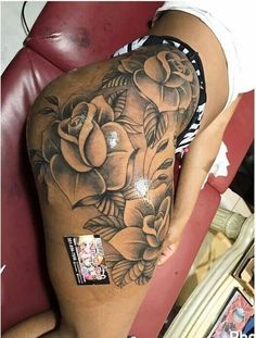 a woman's thigh with flowers on it