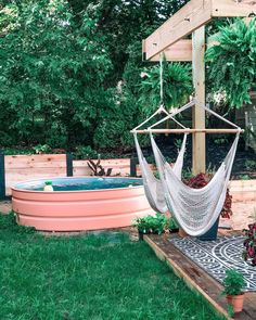 a hammock hanging in the middle of a yard with an above ground pool