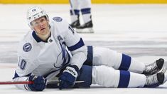 a hockey player is laying on the ice