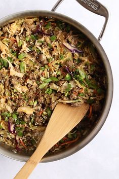 a large pot filled with food and a wooden spoon