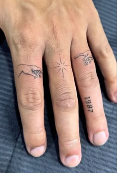 two fingers with tattoos on them that say i love you