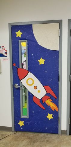 an open door with a rocket ship painted on the side and stars in the background