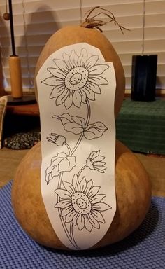 a rock with some flowers drawn on it