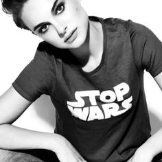 a woman sitting on the ground wearing a star wars shirt