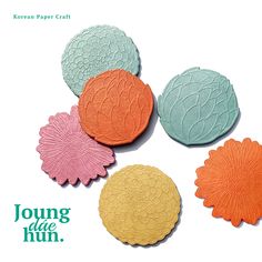 an advertisement for korean paper craft featuring four flower shaped coasters in pastel colors