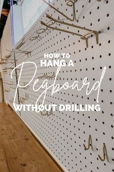 the words how to hang a pegboard without drilling