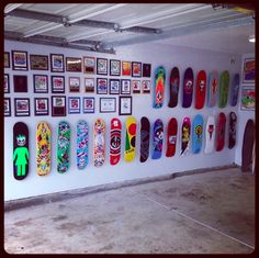 there are many skateboards hanging on the wall