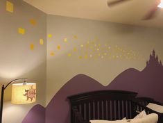 a baby's room with mountains painted on the wall and a crib next to it