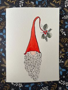 a christmas card with an image of a gnome's head and holly berries on it