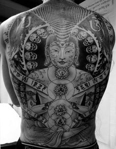 the back of a man's body with tattoos on his chest and head, surrounded by other symbols