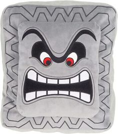 a square pillow with an angry face on the front and sides, all in grey