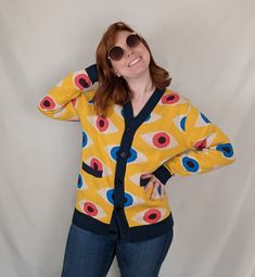 This item is slim-fit. Please use our sizing guide and order one size larger if you are unsure. Drawing inspiration from the iconic Bauhaus movement of the 1950s, our Bauhaus Eyeball Cardigan is a must-have addition to any fashion-forward wardrobe. This unique cardigan features a bold design, with striking red and blue eyes checkering a vibrant yellow backdrop, creating a truly eye-catching (get it?) aesthetic. Long sleeve 100% cotton cardigan Slim-fit sizing Custom Bauhaus Eyeball patterning Da Red And Blue Eyes, Aesthetic Long Sleeve, It Aesthetic, Yellow Backdrop, Unique Cardigan, Bauhaus Movement, The Bauhaus, Eye Pattern, Yellow Cardigan