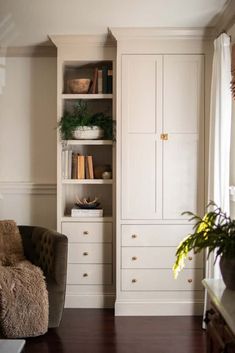 a living room filled with furniture and bookshelves next to a wall mounted bookcase