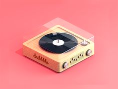 an old fashioned record player on a pink background