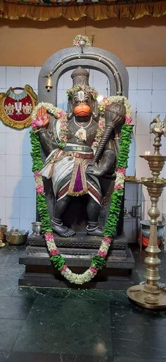 the statue is decorated with flowers and garlands