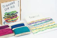 the kit includes several different colored threads and a box with instructions on how to use them