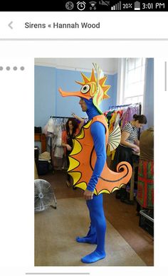 an image of a man dressed as a sea horse in the middle of a room