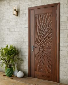 a wooden door sitting next to a potted plant