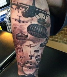 a man's leg with an airplane and hot air balloons on it