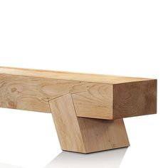 a wooden bench sitting on top of a white floor