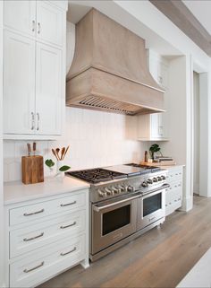 a kitchen with white cabinets and stainless steel stove top oven, which is on instagram