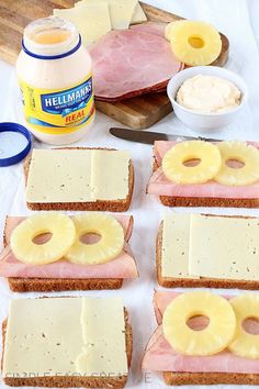 ham, cheese and pineapple slices on bread with butter spread next to the sandwiches